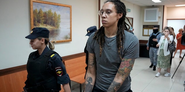 WNBA star and two-time Olympic gold medalist Brittney Griner is escorted from a courtroom in Khimki just outside Moscow, Russia, Aug. 4, 2022.