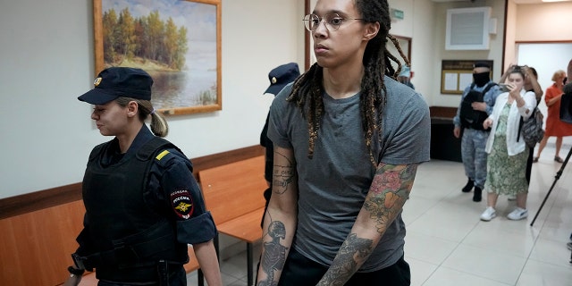 WNBA star and two-time Olympic gold medalist Brittney Griner is escorted from a court room after her last words, in Khimki just outside Moscow, Russia, Thursday, Aug. 4, 2022.