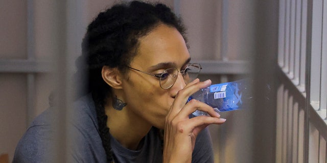 WNBA star and two-time Olympic gold medalist Brittany Griner drinks water as she listens to the verdict in a courtroom in Khimki, outside Moscow, Russia, Aug. 4, 2022.