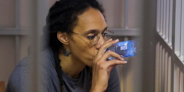 WNBA star and two-time Olympic gold medalist Britney Griner drinks water as she listens to the verdict in a cage in a courtroom in Khimki, a suburb of Moscow, Russia, August 4, 2022.