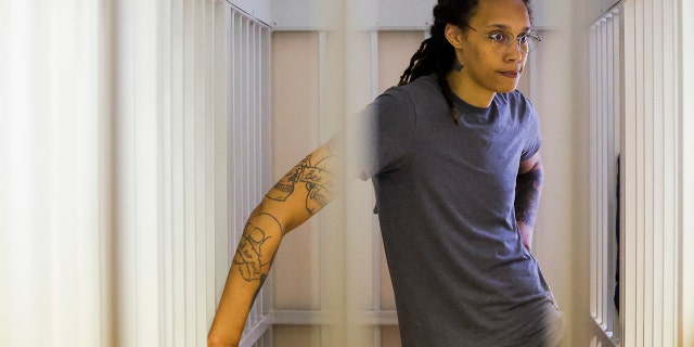 WNBA star and two-time Olympic gold medalist Brittney Griner stands as she listens to the verdict in a courtroom in Khimki just outside Moscow, Russia, Aug. 4, 2022. 