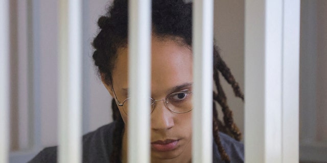 Brittney Griner sits inside a defendants' cage during the reading of the court's verdict in Khimki, outside Moscow, Russia, Aug. 4, 2022.