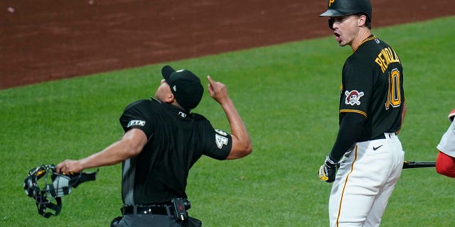 Home plate umpire Roberto Ortiz, left, ejects Pittsburgh Pirates' Bryan Reynolds (10), who had argued a called third strike, during the eighth inning against the Boston Red Sox on Aug. 16, 2022, in Pittsburgh.