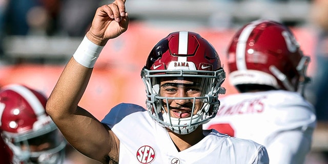 FILE - Alabama quarterback Bryce Young (9) during warm ups before the start of an NCAA college football game against Auburn Saturday, Nov. 27, 2021, in Auburn, Ala.