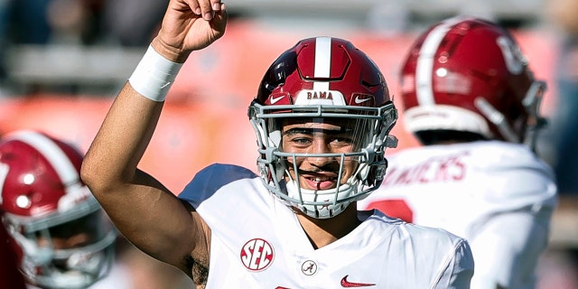 FILE - Alabama quarterback Bryce Young, 9, warms up before the start of NCAA college football against Auburn, Alabama, Saturday, Nov. 27, 2021.