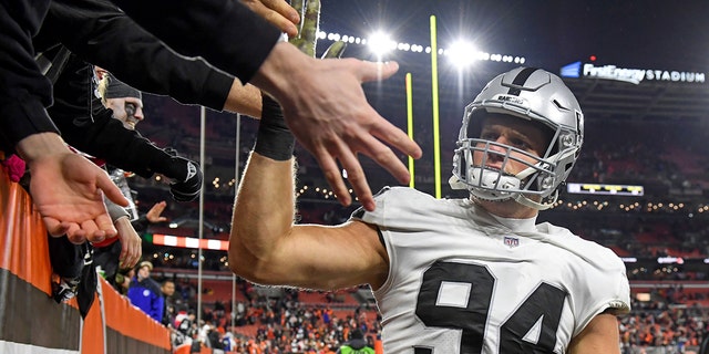 Carl Nassib, #94 of the Las Vegas Raiders, celebrates with fans after the Raiders defeated the Cleveland Browns 16-14 at FirstEnergy Stadium in Cleveland.