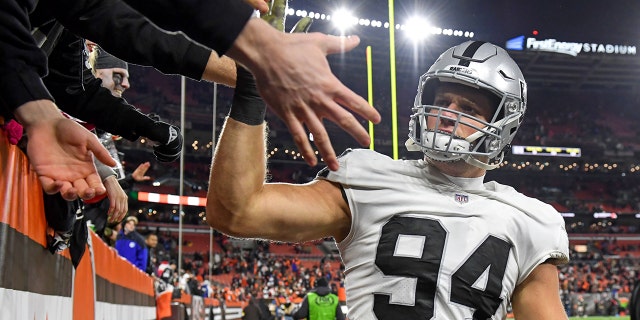 Carl Nassib, #94 of the Las Vegas Raiders, celebrates with fans after the Raiders beat the Cleveland Browns 16-14 at FirstEnergy Stadium in Cleveland.