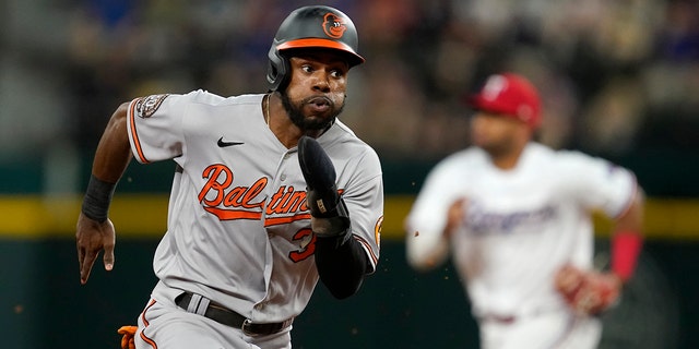 The Baltimore Orioles' Cedric Mullins sprints around third on his way home, scoring on an Adley Rutschman double in the fourth inning against the Texas Rangers, Monday, Aug. 1, 2022, in Arlington, Texas.