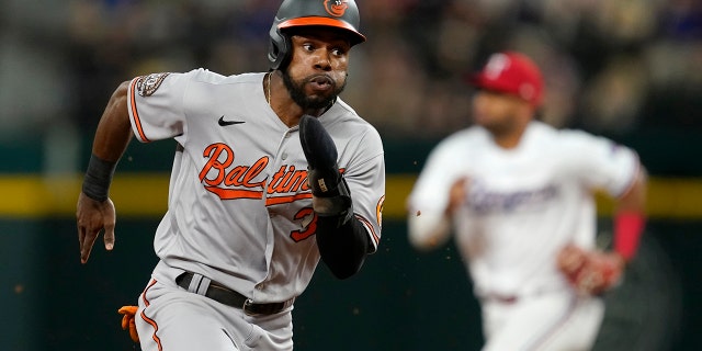 The Baltimore Orioles' Cedric Mullins sprints around third on his way home, scoring on an Adley Rutschman double in the fourth inning against the Texas Rangers, Monday, Aug. 1, 2022, in Arlington, Texas.