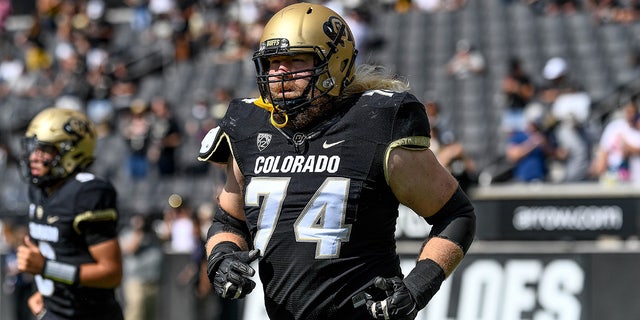 Offensive lineman Chance Lytle, #74 of the Colorado Buffaloes, runs onto the field to start the third quarter of a game against the USC Trojans at Folsom Field on October 2, 2021 in Boulder, Colorado.