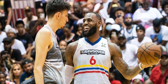 Chet Holmgren greets LeBron James during the CrawsOver Pro-Am game at Seattle Pacific University on Aug. 20, 2022, in Seattle.