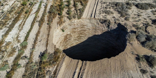 An aerial view taken on Monday, Aug. 1, showing a large sinkhole that appeared over the weekend near the mining town of Tierra Amarilla, Copiapo Province, in the Atacama Desert in Chile.