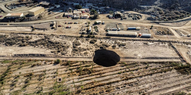 A 328-foot security perimeter has been erected around the hole near the Alcaparrosa mine operated by Canadian firm Lundin Mining.