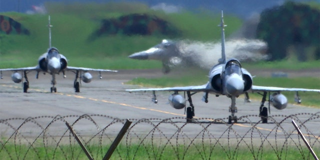 Taiwan Air Force Mirage fighter jets taxi on a runway at an airbase in Hsinchu, Taiwan, on Friday, Aug. 5, 2022.