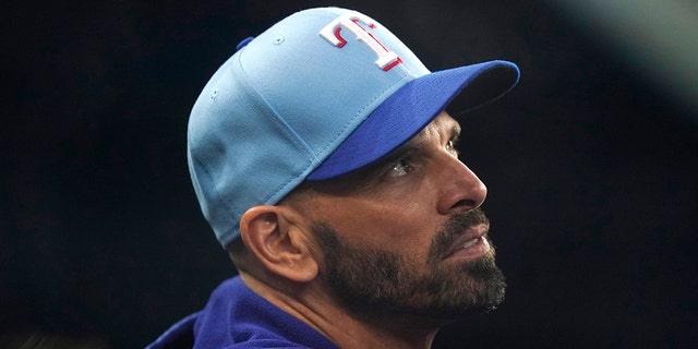 Texas Rangers manager Chris Woodward looks out from the dugout before the team's game against the Seattle Mariners in Arlington, Texas, on Aug. 14, 2022.