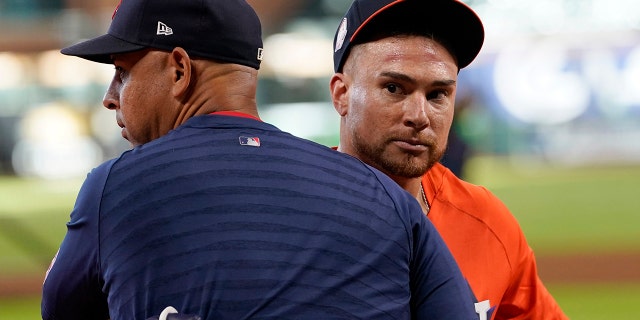 Boston Red Sox manager Alex Cora, left, and Houston Astros' Christian Vazquez hug before a game, Tuesday, Aug. 2, 2022, in Houston. Vazquez was traded from the Red Sox to the Astros on Monday.