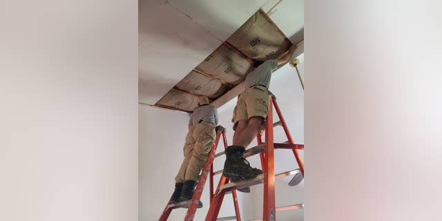 Volunteers make repairs to a home damaged by Hurricane Harvey.