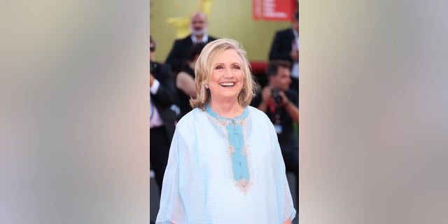 Hillary Clinton smiled while walking down the red carpet at the "White Noise" premiere in Venice on Wednesday.