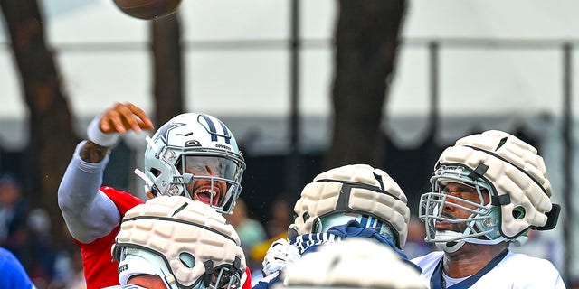 Dallas Cowboys quarterback Dak Prescott throws a pass during NFL football training camp Saturday, July 30, 2022, in Oxnard, Calif. 