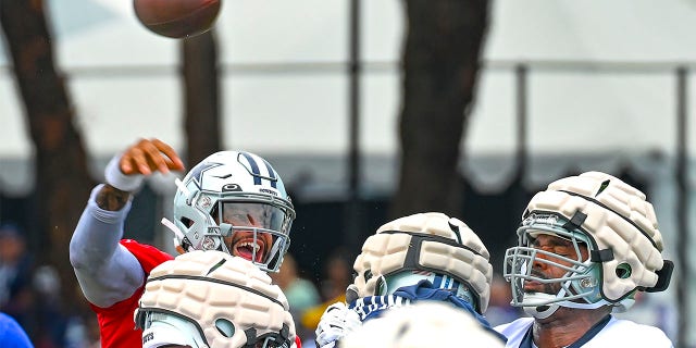 Dallas Cowboys quarterback Dak Prescott throws a pass during NFL football training camp Saturday, July 30, 2022, in Oxnard, Calif.