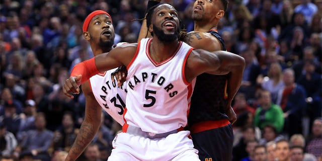 Thabo Sefolosha #25 of the Atlanta Hawks battles for a rebound with Terrance Ross #31 and DeMarre Carroll #5 of the Toronto Raptors defends during the second half of an NBA game at Air Canada Centre on December 16, 2016 in Toronto, Canada.