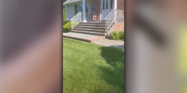 Video shows the father, Devon Tyme, walking up his own driveway to find an agitated man on his front porch.