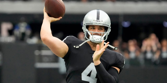 Las Vegas Raiders quarterback Derek Carr warms up before a preseason game in Las Vegas on August 14, 2022.