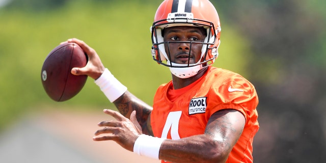 Cleveland Browns quarterback Deshaun Watson prepares to throw a pass during training camp Aug. 1, 2022, in Berea, Ohio.