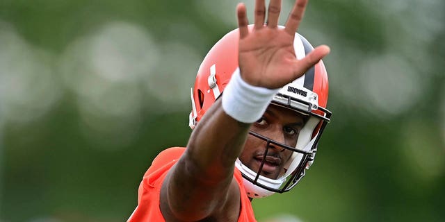 Cleveland Browns quarterback Deshaun Watson waves to fans during an NFL football practice in Berea, Ohio, Sunday, August 14, 2022.