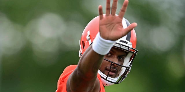 Cleveland Browns quarterback Deshaun Watson waves to fans during an NFL football practice in Berea, Ohio, Sunday, August 14, 2022.