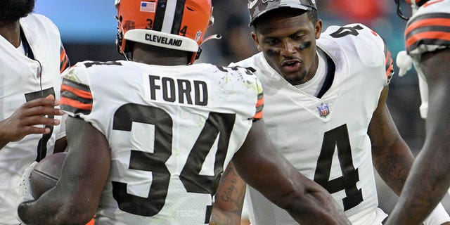 Cleveland Browns quarterback Deshaun Watson, #4, congratulates running back Jerome Ford, #34, after he scored a touchdown against the Jacksonville Jaguars during the first half of an NFL preseason football game, Friday, August 12, 2022, in Jacksonville, Florida.