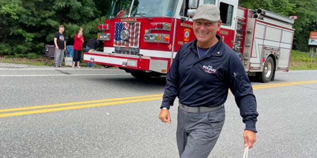 Republican Senate candidate Don Bolduc, a retired Army general, marches in the Merrimack, New Hampshire, July 4th parade.