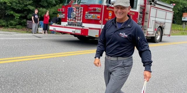 Republican Senate candidate Don Bolduc, a retired Army general, marches in the Merrimack, New Hampshire, July 4th parade.
