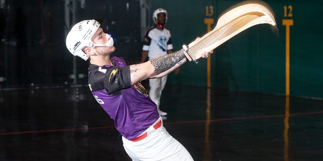 Matthew Langhans throws the pelota against the wall.