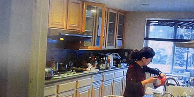 Yu is seen in a screengrab from video opening a bottle of Drano in the kitchen.