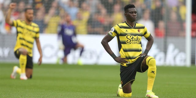 Watford's Ismaila Sarr takes the knee prior to kick-off during the Premier League match between Watford and Newcastle United at Vicarage Road on September 25, 2021 in Watford, England.