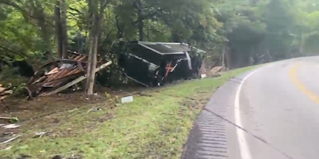 A trailer and other debris is seen strewn along a road in eastern Kentucky.