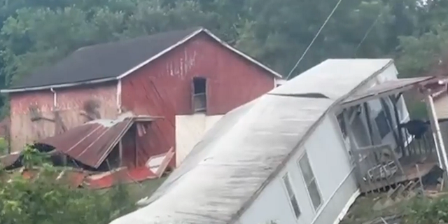 A home is shown toppled in eastern Kentucky following deadly flooding that has killed 37 in the state.