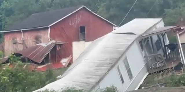 A home is shown toppled in eastern Kentucky following deadly flooding that has killed 37 in the state.