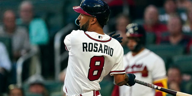 Atlanta Braves' Eddie Rosario follows through on a two-run base hit in the third inning of a baseball game against the Philadelphia Phillies Tuesday, Aug. 2, 2022, in Atlanta.