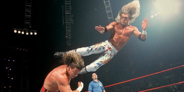 Edge dropkicks Eddie Guerrero.