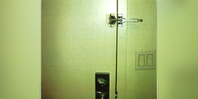 A damaged sling latch above an undamaged door lever