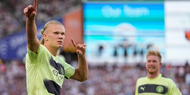 Manchester City's Erling Haaland celebrates after scoring his second goal of the game during the English Premier League soccer match against West Ham United at London Stadium in London, England, Aug. 7, 2022.