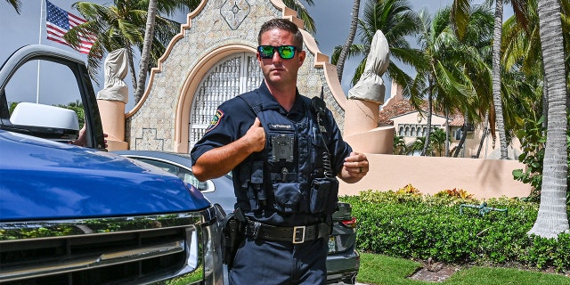 Local law enforcement officers are seen in front of the home of former President Donald Trump at Mar-A-Lago in Palm Beach, Florida, on Aug. 9, 2022.