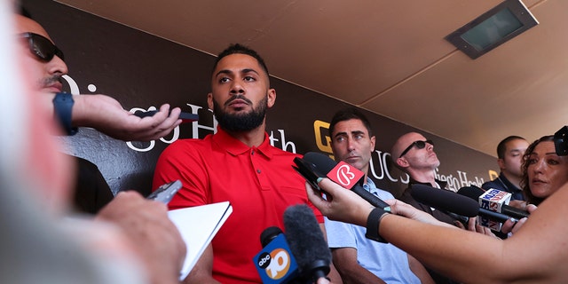 Fernando Tatis Jr., center, of the San Diego Padres, speaks to the media about his 80-game suspension from baseball after testing positive for Clostebol, a performance-enhancing substance in violation of the Joint Prevention and Treatment Program Major League Baseball Drug Court on Tuesday, August 8.  February 23, 2022, in San Diego.