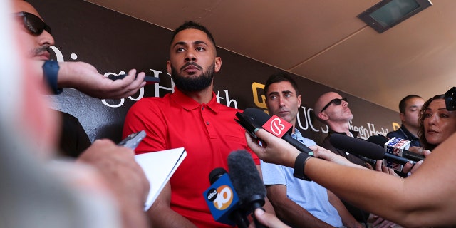 San Diego Padres' Fernando Tatis Jr., center, speaks to the media about his 80-game suspension from baseball after testing positive for Clostebol, a performance-enhancing substance in violation of Major League Baseball's Joint Drug Prevention and Treatment Program, Tuesday, Aug. 23, 2022, in San Diego.