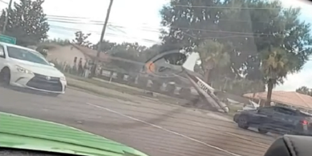 The plane is seen coming to a rest along a road in Orlando, Fla., following the crash landing.