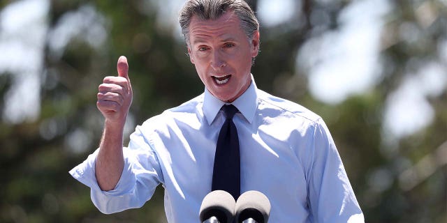 FILE: California Governor Gavin Newsom speaks during a visit to Chabot Place &  Science Center with US Vice President Kamala Harris in Oakland, California on August 12, 2022.  Newsom accused Florida Gov. Ron DeSantis of breaking the law by flying illegal immigrants to Martha's Vineyard, but Newsom appears to have violated a California law that bans travel to certain states. 