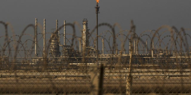 A flame burns off waste gas at Saudi Aramco's Ras Tanura oil refinery and terminal in Ras Tanura, Saudi Arabia. 