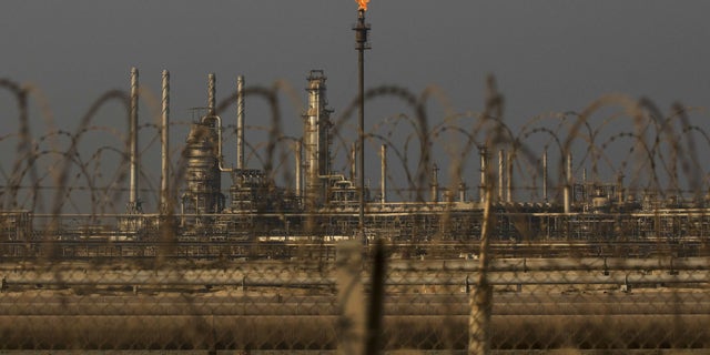 A flame burns exhaust gases from Saudi Aramco's oil refinery and Ras Tanura terminal in Ras Tanura, Saudi Arabia. 
